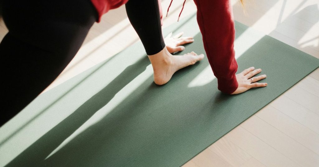 women cleaning yoga mat